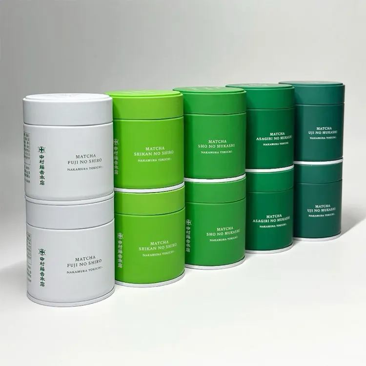 Custom matcha tins with brand printing in graduated green colors